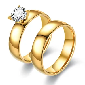 Close-up detail of gold-plated stainless steel four-prong zircon couple ring set