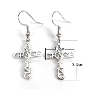 Detailed view of silver stainless steel cross earrings with AMAZING GRACE cutout