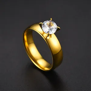 Macro view of a gold-plated stainless steel ring featuring a clear four-prong zircon