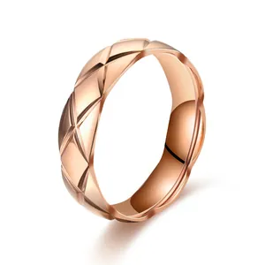 Close-up of rose gold stainless steel ring with elegant quilted pattern detail.