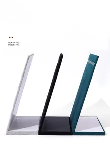 Side view of L-shaped velvet earring display stands in grey, black, and teal colors.