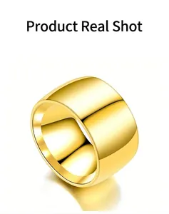 Detailed close-up of a wide gold-colored alloy band ring with a polished plain surface.