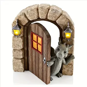 Detail of resin dragon garden statue opening a door under a stone arch with lights