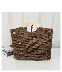Front view of a brown straw woven tote bag with a light wooden handle