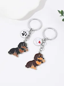 Detailed view of two cute enamel dachshund dog keychains with I Love Dogs charms.