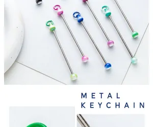 Detailed macro view of metal DIY bead bars with colorful gradient beads for keychains