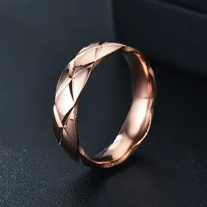 Close-up of rose gold stainless steel ring featuring a quilted diamond-cut pattern detail
