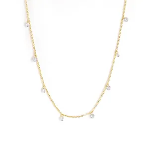 Detailed view of s925 gold-plated necklace with sparkling cubic zirconia hanging charms