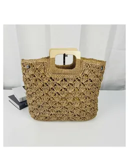Close-up detail of a retro straw woven bag featuring a stylish square wooden handle