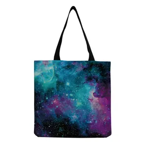 Close-up detail of the vibrant galaxy nebula print on a canvas shoulder tote bag