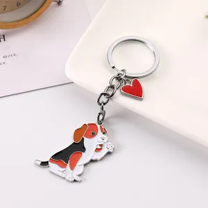 Detailed view of creative enamel waving pet dog keychain with a red heart charm accessory