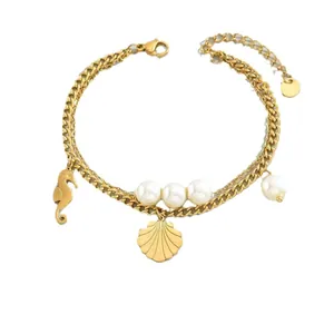 Gold stainless steel layered bracelet featuring faux pearls and shell seahorse charms.