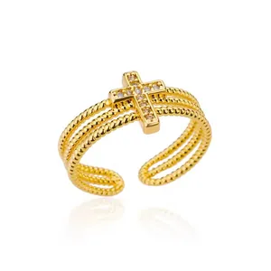 Macro view of a gold-plated open ring featuring a micro-set zircon cross design