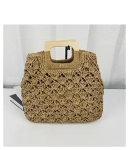 Handmade straw woven tote bag with vintage wooden handle for summer beach holidays