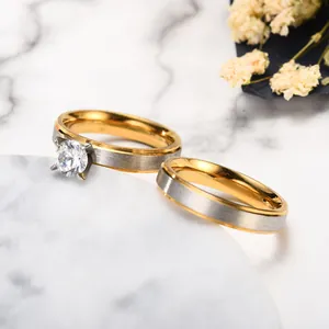 Detailed view of matte two-tone stainless steel couple rings with cubic zirconia stone