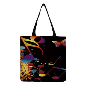 Detail view of black tote bag with colorful musical notes and butterfly print design.