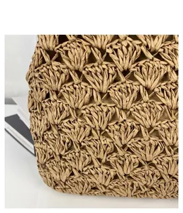 Close-up macro detail of handmade vintage shell-patterned straw woven beach bag texture