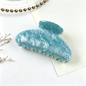 Detailed view of the blue marble acrylic hair claw clip with water pattern design