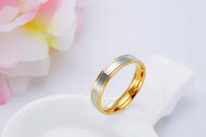 Macro detail showing the matte and polished finish of a two-tone gold and silver stainless steel band