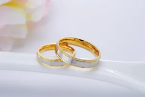 Detailed view of two-tone stainless steel gold-plated couple wedding bands