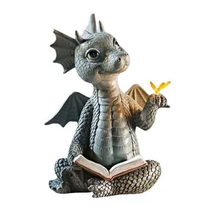 Handcrafted resin baby dragon garden statue reading a book with a yellow butterfly decoration