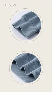 Macro detail showing high-quality ribbed cuffs and hem on blue oversized hoodie fabric.