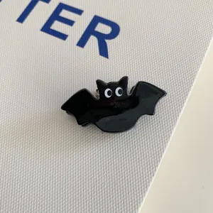 Close-up of a cute black bat acrylic hair claw clip for Halloween party accessory