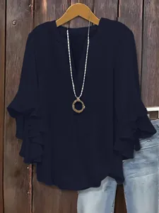 Elegant navy blue V-neck blouse featuring stylish tiered ruffle 3/4 sleeves for women.