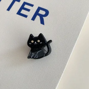 Close-up view of a cute Halloween black cat acrylic hair claw clip with glitter detail