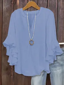 Women's light blue V-neck blouse featuring elegant ruffled three-quarter sleeves
