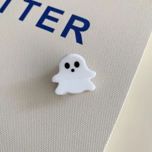 Close-up view of a minimalist white acrylic ghost hair claw clip for Halloween.