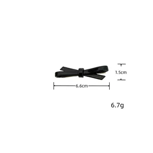 Detailed view of black acetate bow hair clip showing 6.6cm length and 6.7g weight
