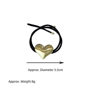 Detailed view of minimalist gold heart alloy hair tie with dimensions and weight