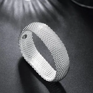Close-up of elegant silver-plated mesh bangle bracelet with fine woven texture