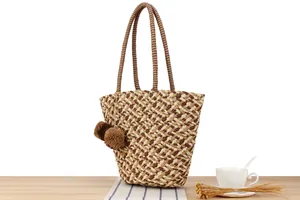 Large woven paper rope tote bag featuring a brown checkered pattern and pom-pom charms