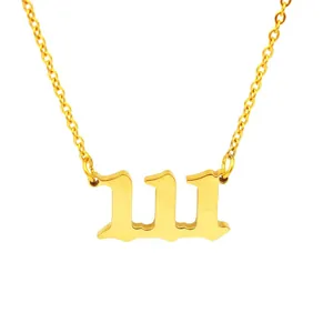 Close-up macro detail of golden 111 angel number pendant on stainless steel chain