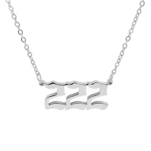Detailed macro view of a silver stainless steel necklace featuring a 222 angel number pendant