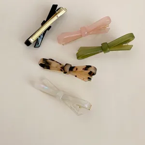 Detail view of colorful acetate bow hair clips in various patterns and colors