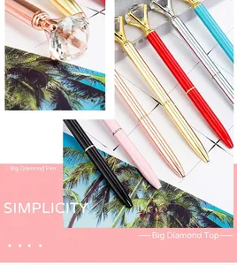 Elegant metal ballpoint pens featuring a large sparkling diamond crystal on top.