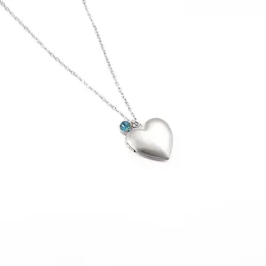 Elegant silver heart locket necklace with blue birthstone pendant in stainless steel