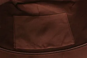 Close-up detail of the durable brown fabric interior lining and inner slip pocket