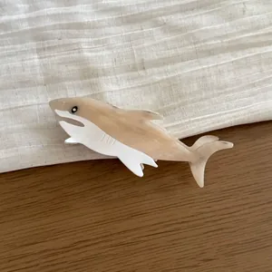 Elegant acetate hair claw clip featuring a unique shark shape in cream and white tones
