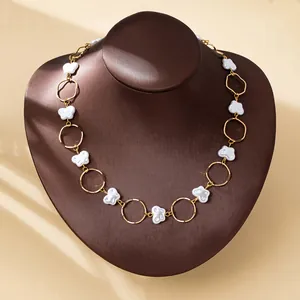 Elegant baroque faux pearl necklace with butterfly charms on a jewelry display bust.