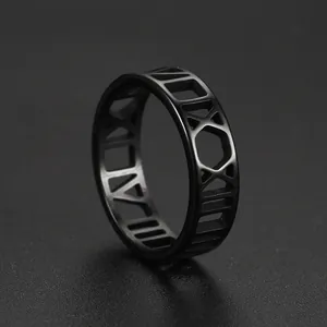 Macro view of a matte black stainless steel ring featuring cutout Roman numeral details