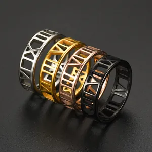 Detailed view of four Roman numeral stainless steel rings in varied metallic finishes.
