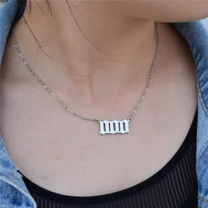 Close-up of silver stainless steel Gothic 111 angel number necklace worn on neck