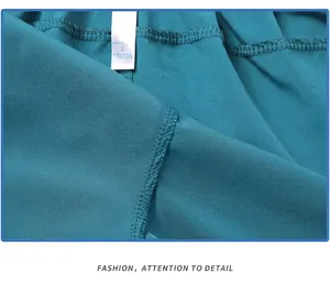 Close-up of high-density reinforced stitching and size tag on teal blue athletic shorts