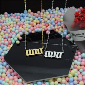 Detail view of gold and silver stainless steel gothic angel number 1111 necklaces.