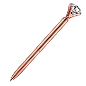 Elegant rose gold metal ballpoint pen topped with a large sparkling diamond