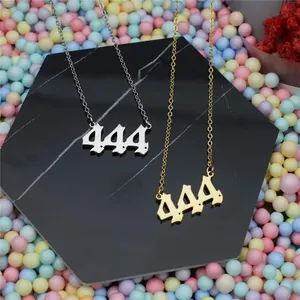 Detail shot of gold and silver stainless steel 444 angel number pendant necklaces.